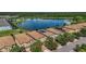 Aerial view of a townhome nestled in a community by a lake at 8869 Rhodes St, Kissimmee, FL 34747