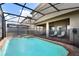 View of refreshing pool and spa with screened enclosure at 8869 Rhodes St, Kissimmee, FL 34747