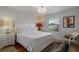 Main bedroom with white bedding and a window with blinds at 8869 Rhodes St, Kissimmee, FL 34747