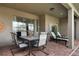Patio with table, chairs, and lounge chairs next to the house at 8869 Rhodes St, Kissimmee, FL 34747