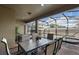Covered patio with table and chairs, overlooking a screened pool at 8869 Rhodes St, Kissimmee, FL 34747