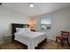 Bright bedroom with a queen-size bed and wood-look floors at 8869 Rhodes St, Kissimmee, FL 34747