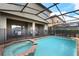 Screened pool and spa with brick coping and a covered patio at 8869 Rhodes St, Kissimmee, FL 34747