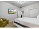 Bright bedroom with large TV, comfy chair, and updated flooring at 8869 Rhodes St, Kissimmee, FL 34747