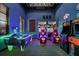 Bright game room featuring air hockey and racing games at 8869 Rhodes St, Kissimmee, FL 34747