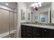 Bathroom with double vanity, granite countertop, and a shower/tub combo at 8869 Rhodes St, Kissimmee, FL 34747