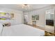 Bright bedroom with ensuite bathroom access, featuring a large bed and neutral decor at 8869 Rhodes St, Kissimmee, FL 34747