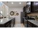 Modern kitchen with dark cabinetry, granite counters, and stainless steel appliances at 8869 Rhodes St, Kissimmee, FL 34747