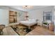 Bedroom with a queen bed, stylish rug, and light wood floors at 8869 Rhodes St, Kissimmee, FL 34747