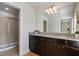 Modern bathroom with dark brown vanity, granite countertop, and a walk-in shower at 8869 Rhodes St, Kissimmee, FL 34747