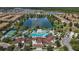 Aerial view of community amenities including pool, clubhouse, and lake at 8869 Rhodes St, Kissimmee, FL 34747
