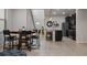 Open concept dining area with rustic table and modern chairs, adjacent to kitchen at 8869 Rhodes St, Kissimmee, FL 34747
