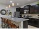 Spacious kitchen featuring dark wood cabinets and granite island at 8869 Rhodes St, Kissimmee, FL 34747