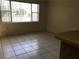 Kitchen with tile floor and large window overlooking the street at 1106 N Hoagland Blvd, Kissimmee, FL 34741