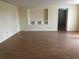 Living room featuring hardwood floors and built-in shelving at 1106 N Hoagland Blvd, Kissimmee, FL 34741