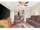 Living room with brown reclining chairs, large TV, and view to dining area at 4092 Gay Nell Ct, Orlando, FL 32811