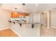 Kitchen with granite countertops, light wood cabinets, and a breakfast bar at 2807 Strand Loop Ct, Oviedo, FL 32765