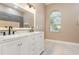 Elegant bathroom with double vanity, marble countertop, and large mirror at 2807 Strand Loop Ct, Oviedo, FL 32765