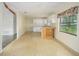 Kitchen with white cabinets and vinyl flooring, open to dining area at 16 Cypress Dr, Eustis, FL 32726
