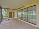 Screened porch with sliding glass doors and lake view at 16 Cypress Dr, Eustis, FL 32726