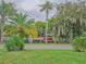Scenic waterfront view with lush vegetation and a red dock at 16 Cypress Dr, Eustis, FL 32726