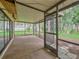 Screened porch overlooking backyard and trees at 16 Cypress Dr, Eustis, FL 32726