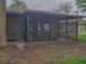 Screened porch with sliding glass doors and concrete floor at 16 Cypress Dr, Eustis, FL 32726