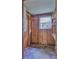 Unfinished room with plywood walls and concrete floor at 16 Cypress Dr, Eustis, FL 32726