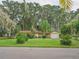 Ranch style home with a white garage door and manicured lawn at 16 Cypress Dr, Eustis, FL 32726
