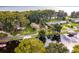 Aerial view showcasing waterfront property with canal access and lush vegetation at 16 Cypress Dr, Eustis, FL 32726