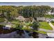 Lakeside property with two houses and lush vegetation at 16 Cypress Dr, Eustis, FL 32726