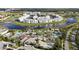 Aerial view of community with lake, pools, and clubhouse at 4751 Clock Tower Dr # 105, Kissimmee, FL 34746