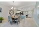 Open concept kitchen with island, stainless steel appliances, and dining area at 4751 Clock Tower Dr # 105, Kissimmee, FL 34746