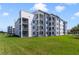 Modern building exterior with balconies and landscaping at 4751 Clock Tower Dr # 105, Kissimmee, FL 34746