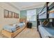 Bright bedroom with twin beds, nightstand, and ample natural light at 4751 Clock Tower Dr # 105, Kissimmee, FL 34746