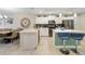 Modern kitchen boasts stainless steel appliances and an island with seating at 4751 Clock Tower Dr # 105, Kissimmee, FL 34746