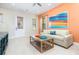 Bright living room with comfortable seating and large artwork at 3074 Key Lime Loop, Kissimmee, FL 34747