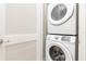 Stackable Samsung washer and dryer in a laundry closet at 3074 Key Lime Loop, Kissimmee, FL 34747