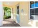 Front entrance with covered porch and light teal door at 3074 Key Lime Loop, Kissimmee, FL 34747