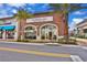 Brick building housing Flower Cafe bakery and coffee shop, featuring outdoor seating at 3074 Key Lime Loop, Kissimmee, FL 34747