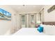 King bedroom with mounted TV and large windows at 3074 Key Lime Loop, Kissimmee, FL 34747
