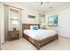 King bedroom with wood platform bed, nightstands, and large windows at 3074 Key Lime Loop, Kissimmee, FL 34747