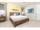 Main bedroom with king-size bed, wooden frame, and beach theme decor at 3074 Key Lime Loop, Kissimmee, FL 34747