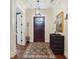 Elegant entryway with hardwood floors, stained glass door and dark wood console at 1041 Cottontail Ln, Maitland, FL 32751