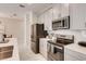 Modern kitchen with stainless steel appliances and gray cabinets at 408 Ocean Course Ave, Davenport, FL 33896