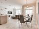 Open concept dining room with modern table and chairs, adjacent to the kitchen at 408 Ocean Course Ave, Davenport, FL 33896