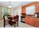 Eat-in kitchen with wood cabinets, a round table and chairs at 250 White Marsh Cir, Orlando, FL 32824
