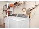 Bright laundry room with washer, dryer, and shelving at 250 White Marsh Cir, Orlando, FL 32824