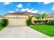 House exterior featuring a two-car garage and manicured lawn at 250 White Marsh Cir, Orlando, FL 32824