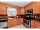 Kitchen with light wood cabinets, stainless steel appliances, and granite countertops at 250 White Marsh Cir, Orlando, FL 32824